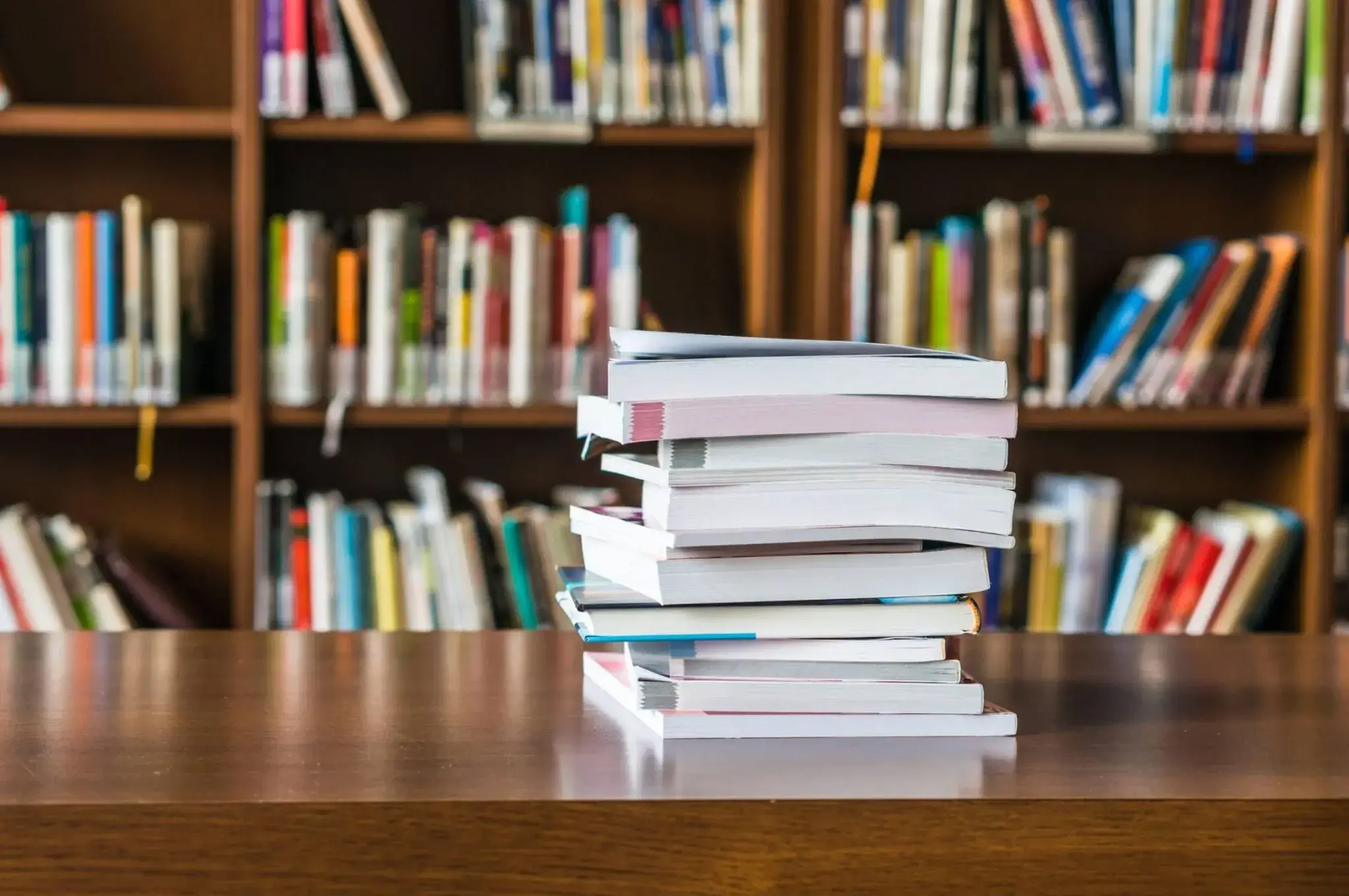 A stack of art books on a table
