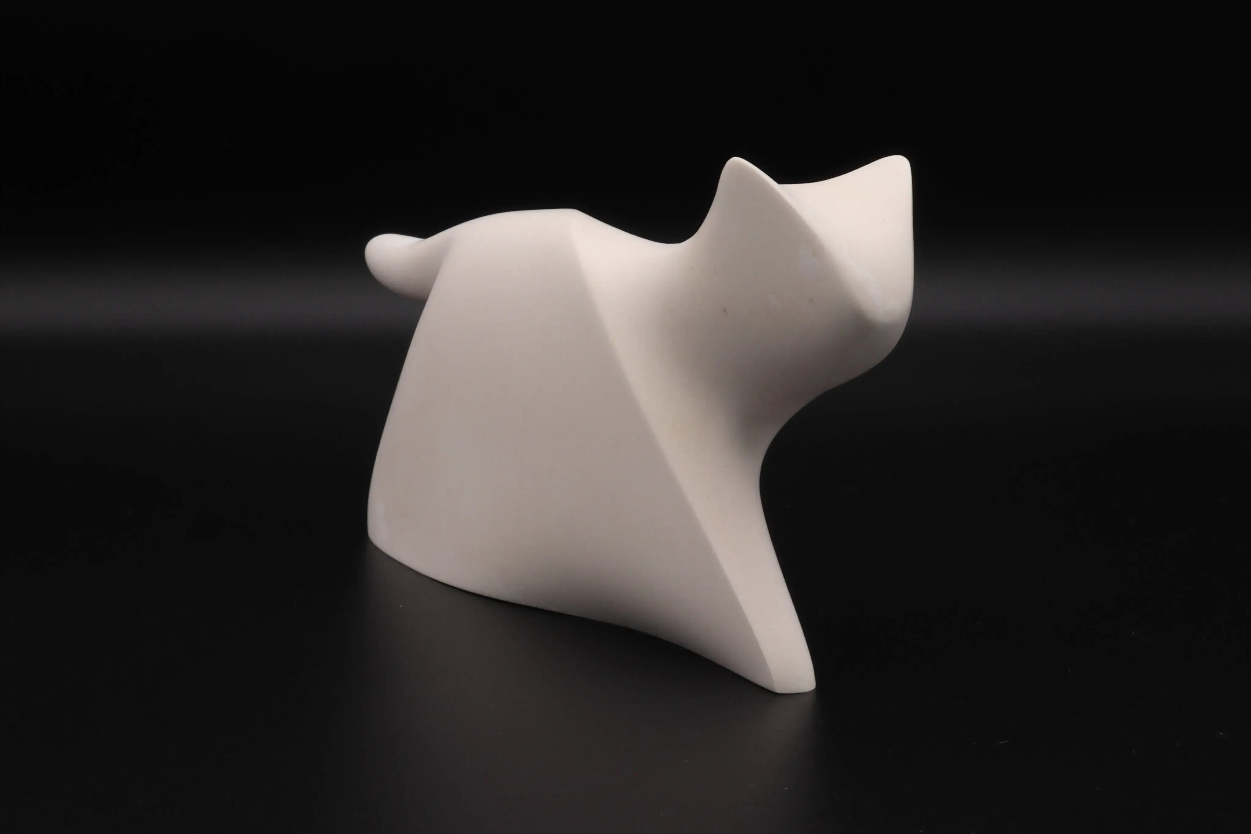 A minimalist sculpture casting a long shadow